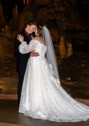 Cave wedding with bride and groom embracing.