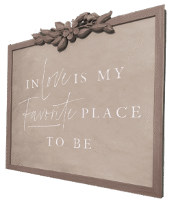 A sign that says, "in love is my favorite place to be". This is on the wall of the honeymoon suite at The Ross Mansion at Marengo Cave.