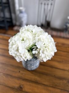 A bouquet of white flowers as a centerpiece on the living room end table